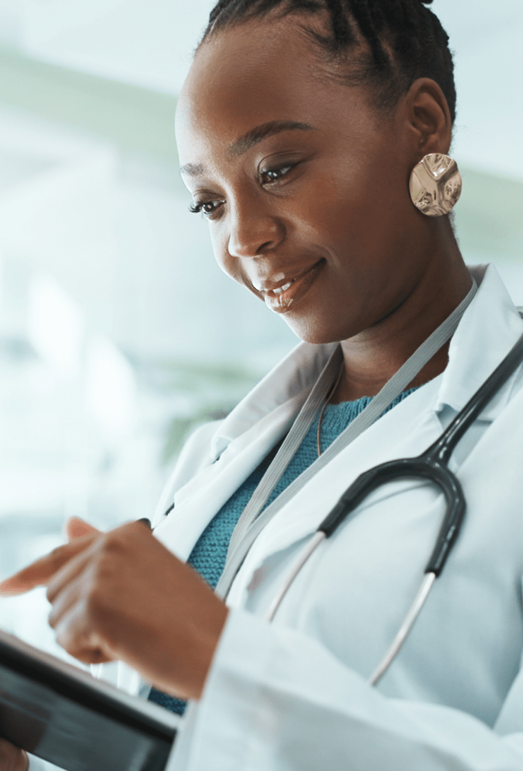 Doctor checking her reports with on a tablet